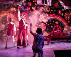 Small Alison (foreground: Lila Gold) fantasizes about her favorite TV show coming to life in her living room, complete with singers and dancers (l to r: Ayelet Firstenberg, Michael Doppe, Erin Kommor) in “Fun Home,” presented by TheatreWorks Silicon Valley October 1-28 at the Mountain View Center for the Performing Arts.
NOTE: Lila appears in performances on October 3, 5, 6, 7 (7pm), 9, 11, 12, 13 (8pm), 14 (2pm), 17, 19, 20 (8pm), 21 (2pm), 24 (7:30pm), 25 (2pm), 26, 27.