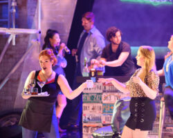 Pictured: Cara Collins (left) as Brittomara, a shape-shifting devil appearing here as a bartender, and Edith Grossman (right) as Rachel in the world premiere of "If I Were You" by Jake Heggie and Gene Scheer, presented by Merola Opera Program, August 1-6 at the Herbst Theatre in San Francisco.