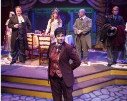 Edwin Drood (foreground: Chloë Angst) prepares to leave a Christmas Eve dinner party attended by friends and family (l to r: Rachelle Abbey, Aaron Hurley, Brenna Sammon, Benjamin Ball, Zach Goller) in "The Mystery of Edwin Drood," presented by Foothill Music Theatre February 27 - March 8 at the Lohman Theatre in Los Altos Hills.