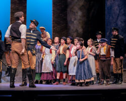 L-R: Morales (Peter Morgan) and Don José (Noah Stewart) are mocked by a gang of street urchins played by the lauded CANTA (California Academy of Novel and Traditional Arts) children’s chorus in Opera San José's "Carmen" at the California Theatre, Feb. 12-27, 2022.