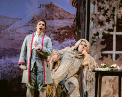 Isolier (Meg Brilleslyper), unaware the hermit is Le Comte Ory (Minghao Liu), confides his love for Comtesse Adèle and his plan to slip into the castle in Merola Opera Program’s "Le Comte Ory," Jul. 31 & Aug. 2, 2025, at the San Francisco Conservatory of Music’s Caroline H. Hume Concert Hall.